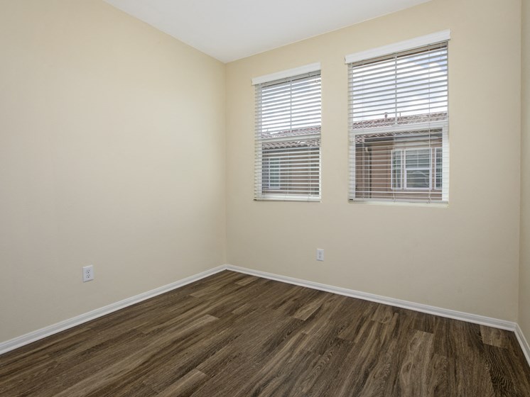 Parkside Villas unfurnished bedroom with wooden floors and window